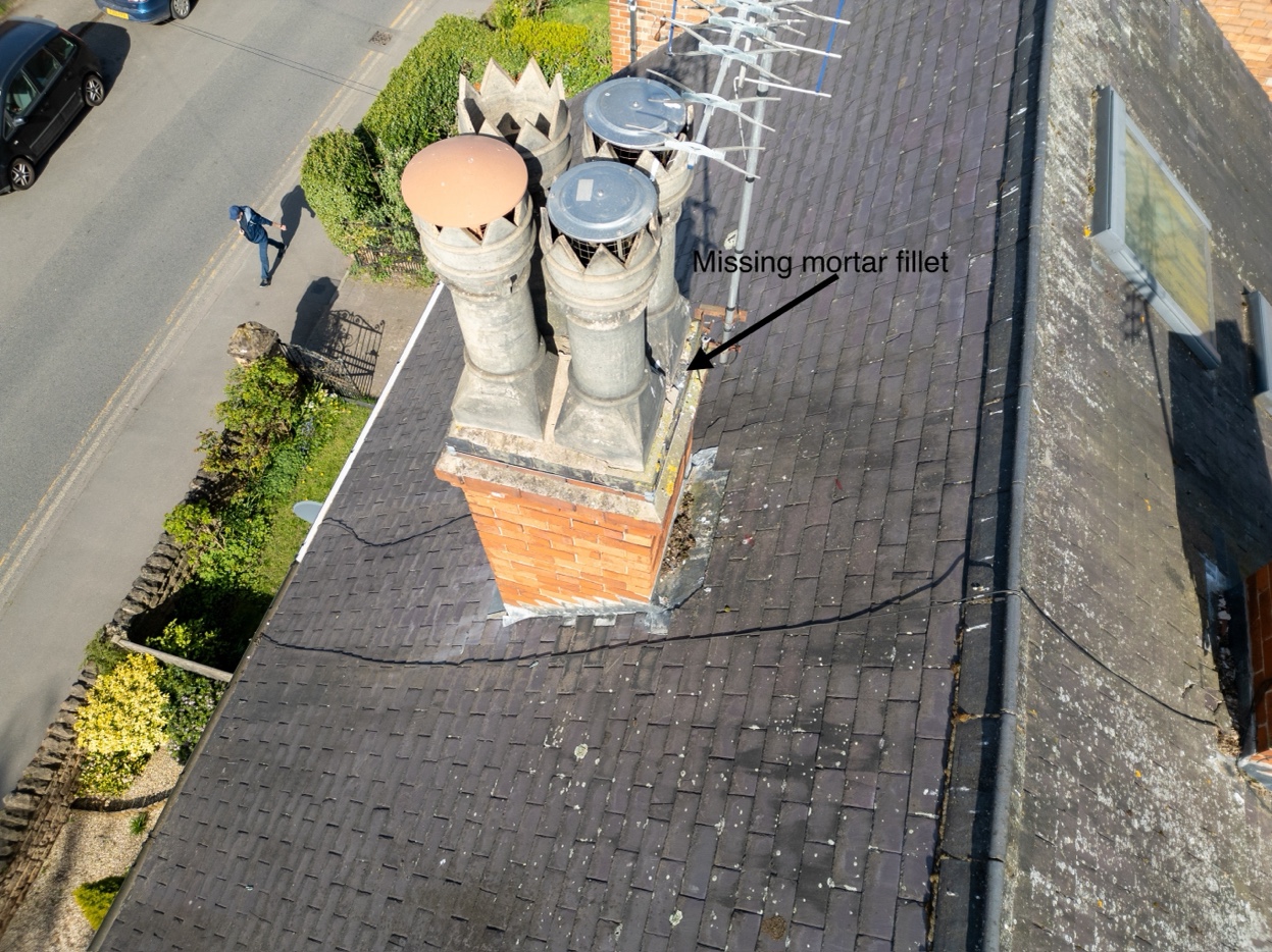 Drone survey image showing annotated roof defect — missing mortar fillet identified on chimney