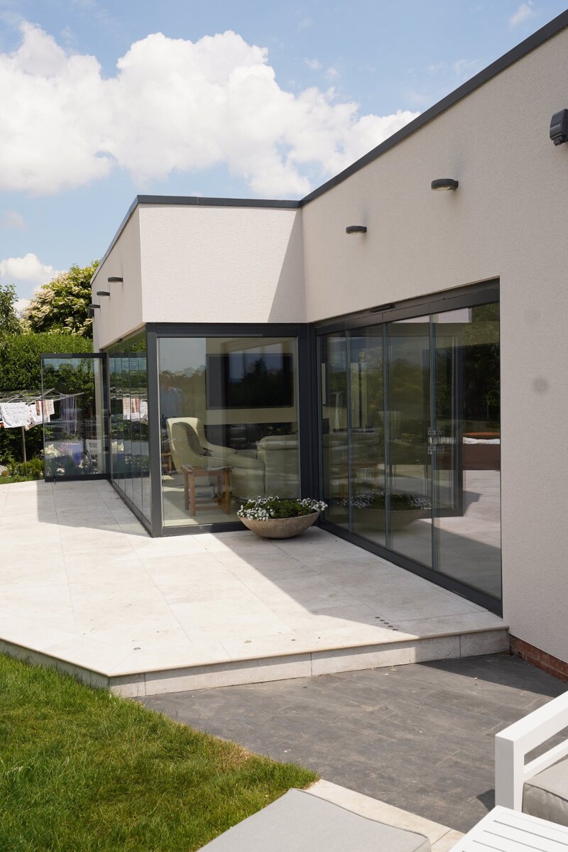 Modern glass extension with patio and garden in Nottinghamshire by Doherty Build