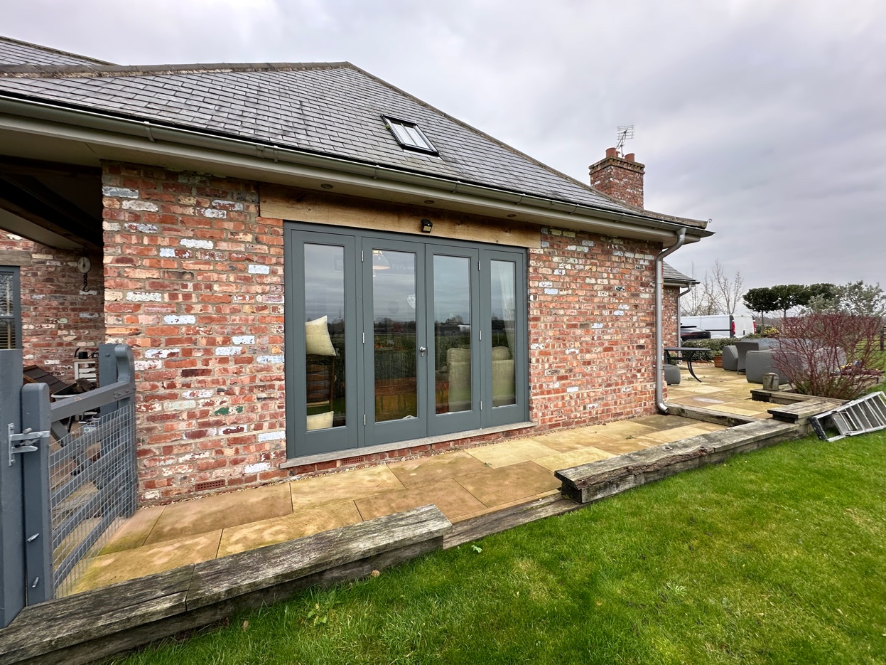 Anthracite French doors fitted to brick rural property extension with countryside views